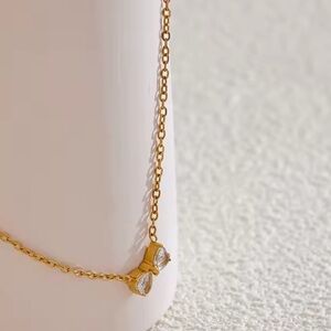 Stainless Steel, Gold Plated
Matching ring, sold separately 
Gold Bow Necklace